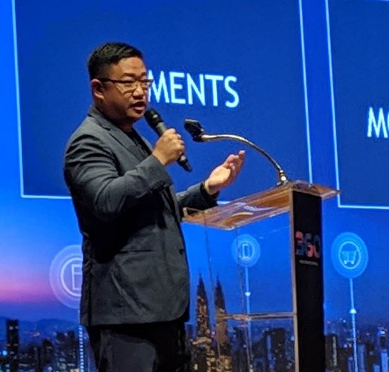 CEO Don Guo sharing about the benefits of blockchain at a tech conference in Cambodia